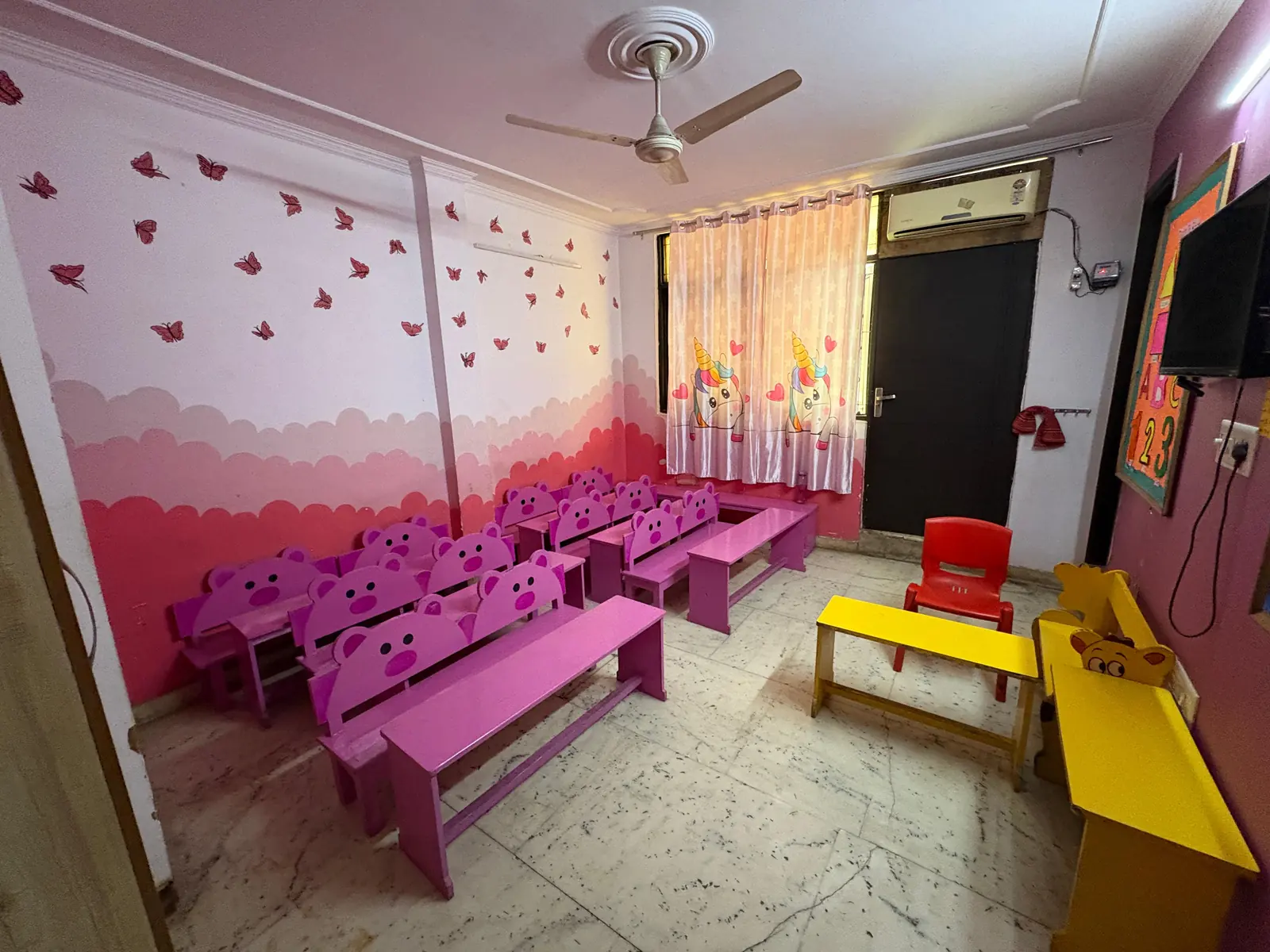 Air-conditioned classroom with child-height furniture at Buzzy Bees preschool, West Patel Nagar