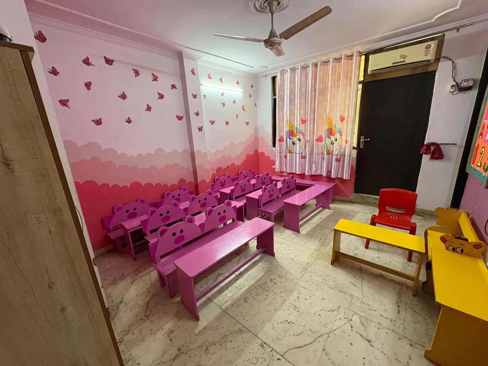 Bright air-conditioned classroom at Buzzy Bees preschool in West Patel Nagar, with child-height benches