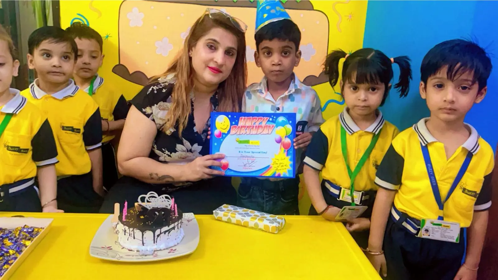 Birthday celebration at Buzzy Bees play school in West Patel Nagar, with cake and a certificate for the birthday child